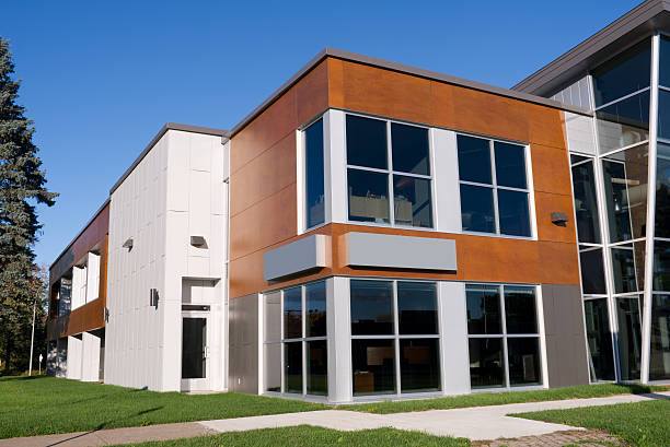 Office building with freshly painted exterior panels in warm brown and white by a painter in Spartanburg, SC.