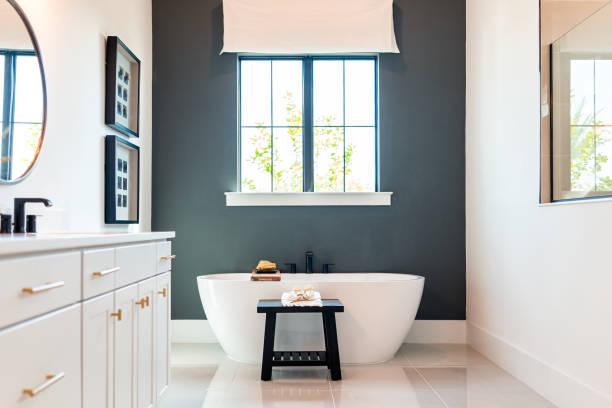 Bathroom with a charcoal gray accent wall and an eggshell paint finish by an interior painter in Tyron, NC.