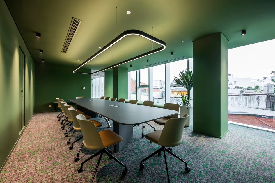 Office conference room with deep green painted walls and contemporary finishes, by a painting company in Travelers Rest, NC.