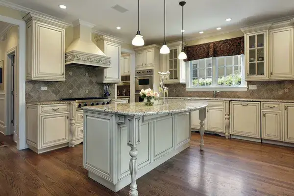 Kitchen featuring cream-colored cabinets with detailed trim by a painting company in Simpsonville, SC.