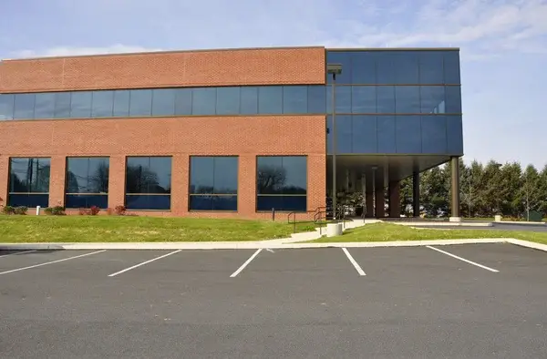 Office building with brick wall and clean paint finishes by an exterior painter in Greer, SC.