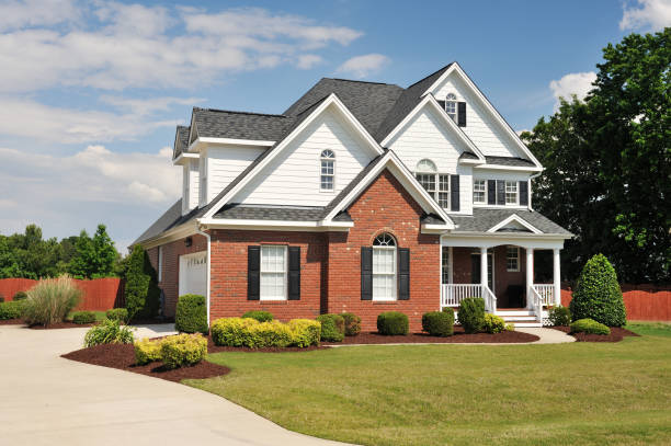 Brick and white home with freshly painted black shutters and crisp white trim by exterior painters in Lyman, NC